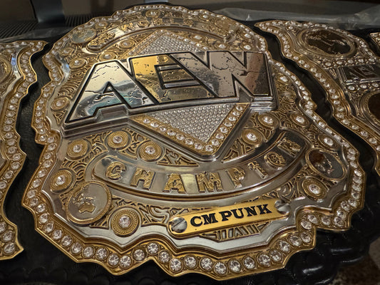 Customized nameplates for official AEW World Championship replica belts.